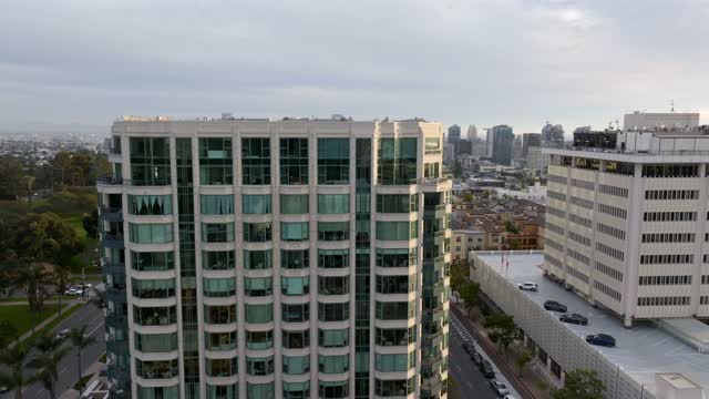 Low aerial view of the downtown streets, the skyline and homes at Bankers Hill.