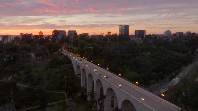 Low aerial view of a park, the bridge and the skyline at Bankers Hill.