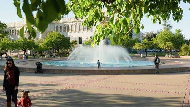 A park, the buildings and open country in Balboa Park, with people walking.
