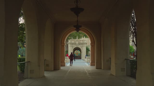 A park, the buildings and open country in Balboa Park, with people walking.