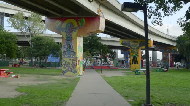 A park, the bridge and the buildings in Barrio Logan.