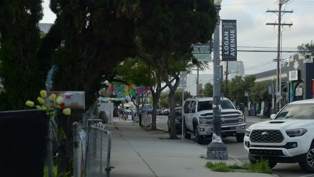The downtown streets, the buildings and the city in Barrio Logan, with people walking.