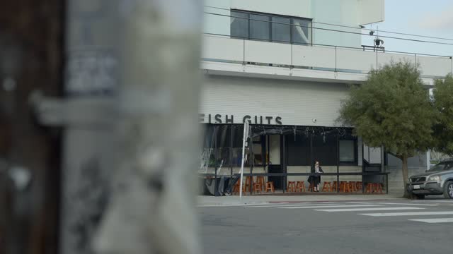 The downtown streets, the buildings and the city in Barrio Logan, with people walking.