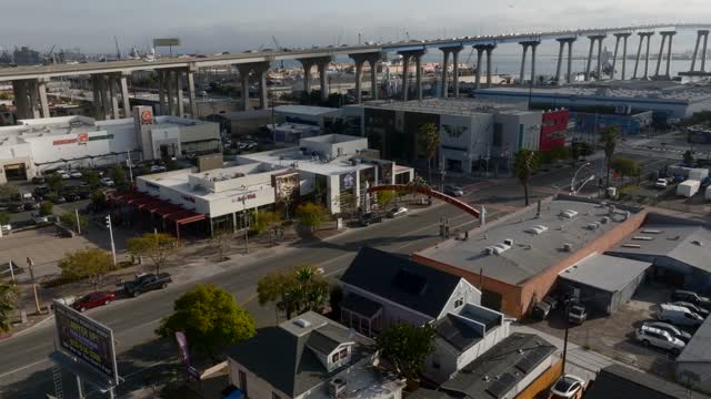 Low aerial view of the downtown streets, the bridge and the buildings in Barrio Logan.