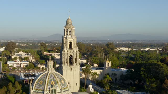 Low aerial view of a park, palm trees and the buildings in Balboa Park.