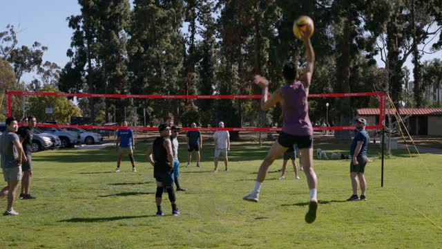 A park, traffic and open country in Balboa Park, with a crowd gathered.