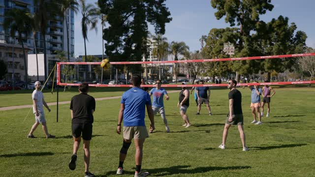 A park, palm trees and the buildings in Balboa Park, with a crowd gathered.