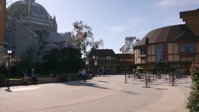 A park, the buildings and open country in Balboa Park, with people walking.