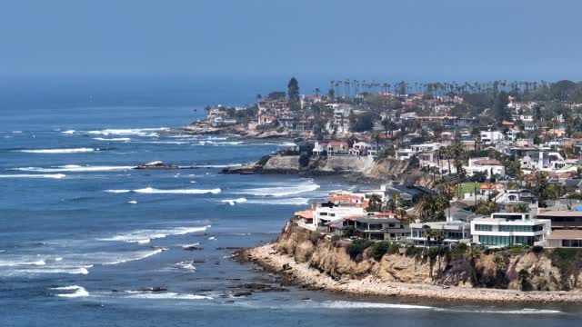 Elevated view of the cliffs, the surf and palm trees in Pacific Beach.