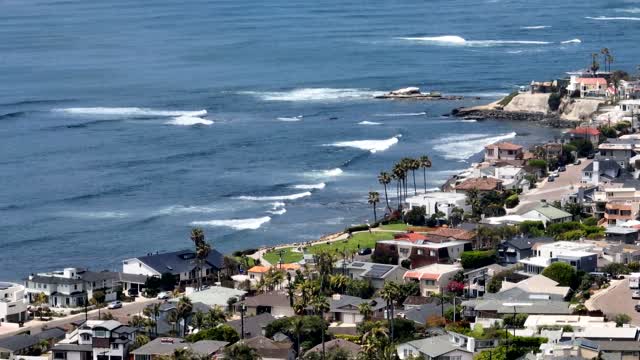 Aerial view of a residential street, the surf and palm trees in Pacific Beach.