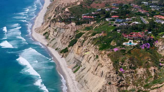 Aerial view of the cliffs, the surf and the ocean at Black’s Beach.