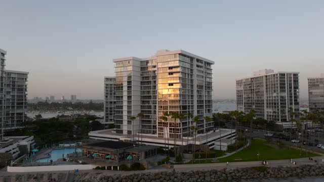 Low aerial view of a residential street, boats and palm trees at Coronado Beach.