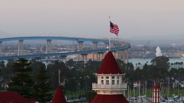 Low aerial view of the harbor, the bridge and boats at Coronado Beach.