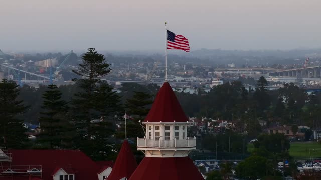 Low aerial view of the downtown streets, the bridge and the buildings at Coronado Beach.