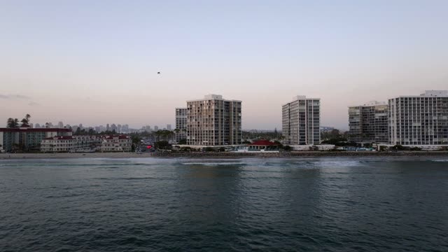 Low aerial view of the beach, the surf and the ocean at Coronado Beach.