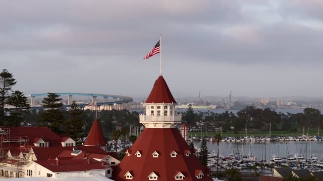 Low aerial view of the harbor, the bridge and boats at Coronado Beach.