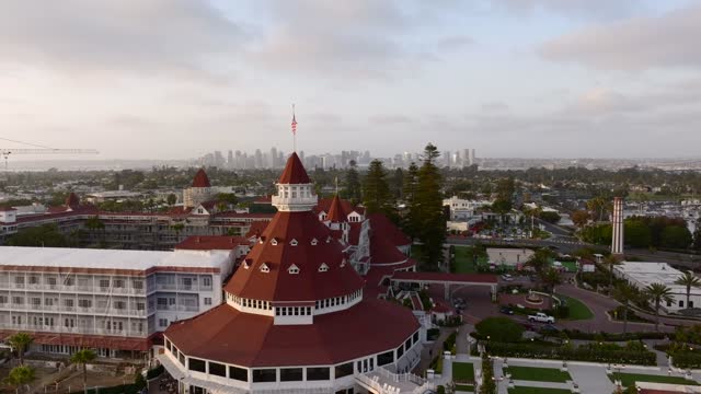 Low aerial view of the downtown streets, the skyline and palm trees at Coronado Beach.