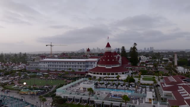 Low aerial view of the beach, the skyline and palm trees at Coronado Beach.
