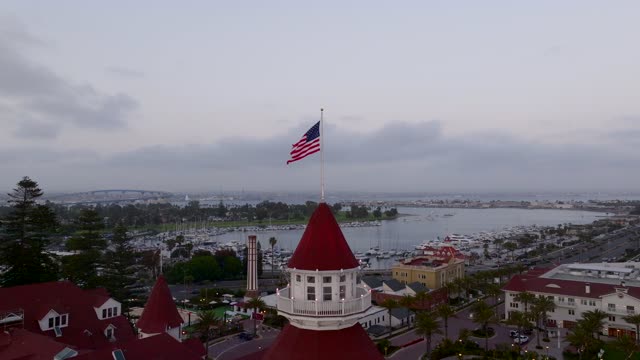 Low aerial view of the harbor, the bridge and boats at Coronado Beach.