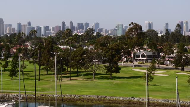 A park, the skyline and boats at Glorietta Bay.