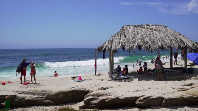 The beach, the surf and the ocean at Windansea, with a crowd gathered.