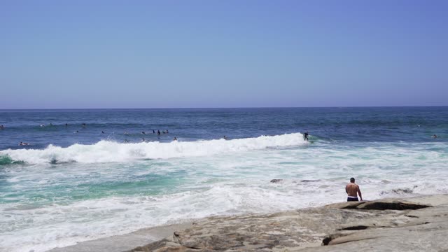 The beach, the surf and the ocean at Windansea, with surfers out.