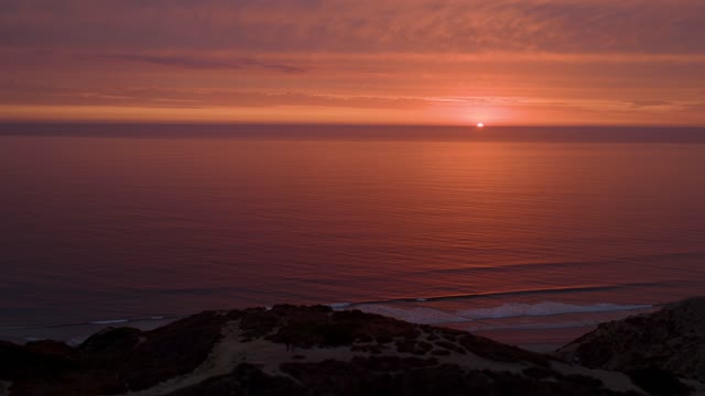 Elevated view of the cliffs, the surf and the ocean at Black’s Beach.
