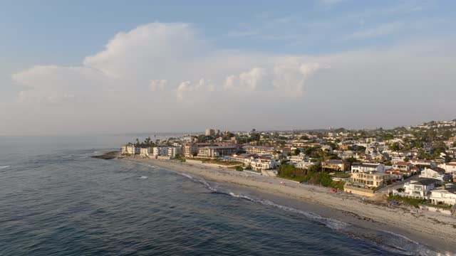 Aerial view of the beach, the surf and palm trees at Beach Barber Tract.
