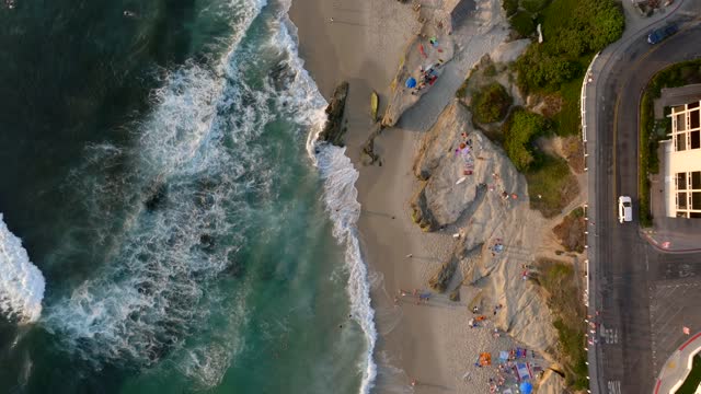 Aerial view of the beach, the surf and the ocean at Beach Barber Tract, with people walking.
