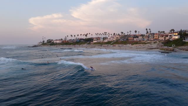 Surfers during Sunset and Twilight at Windansea Beach at the Beach Barber Tract coastline in La Jolla San Diego | Drone Video – 1