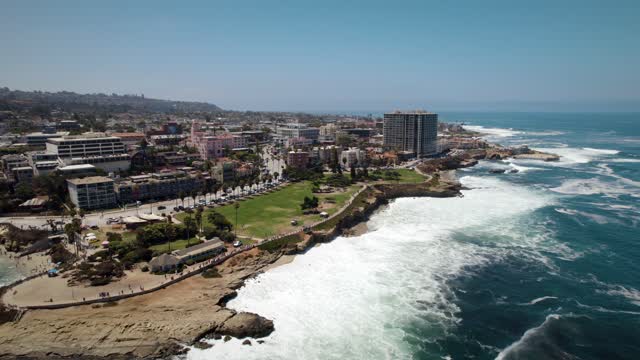Aerial view of the cliffs, the surf and the ocean at La Jolla Cove.