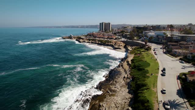 Aerial view of the cliffs, the surf and the ocean at La Jolla Cove.