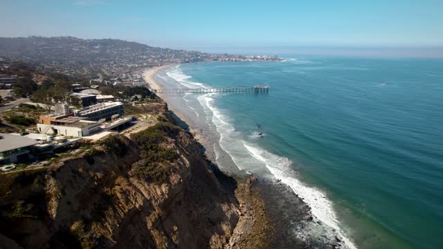 Aerial view of the cliffs, the pier and the ocean at La Jolla Shores.