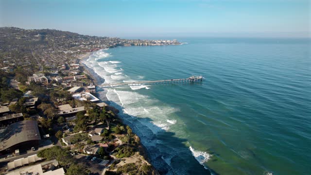 Aerial view of the beach, the surf and the pier at La Jolla Shores.