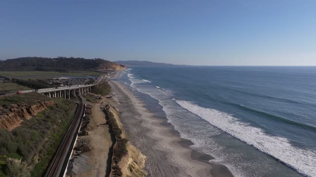 Aerial view of the cliffs, the surf and the bridge in Del Mar.