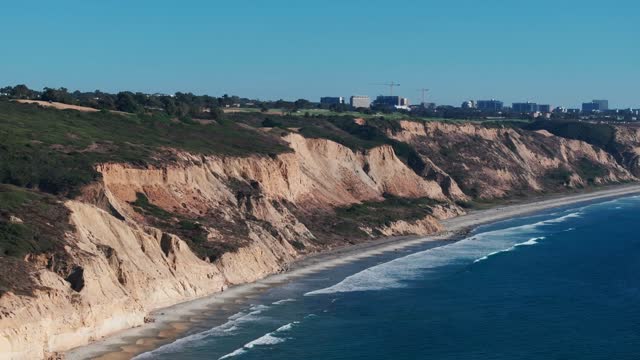 Aerial view of the cliffs, the surf and the skyline at Torrey Pines.