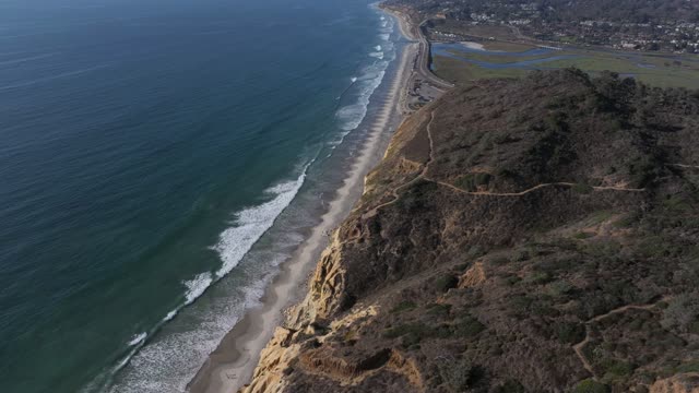 Aerial view of the cliffs, the surf and the ocean at Torrey Pines.