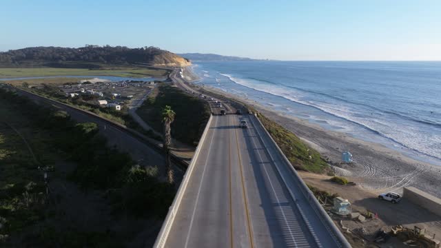 Low aerial view of the cliffs, the ocean and the beach in Del Mar.