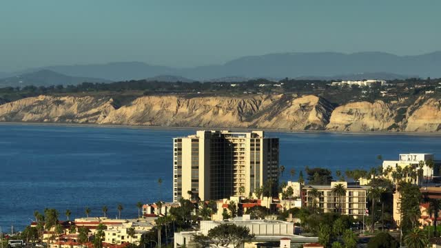 Elevated view of a residential street, palm trees and the ocean at Village of La Jolla.