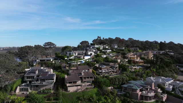Low aerial view of a residential street, homes and the buildings in Del Mar.