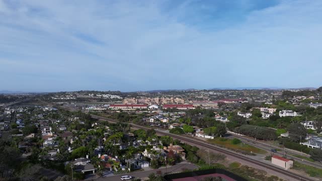 Aerial view of a residential street, palm trees and homes at Del Mar Dog Beach.