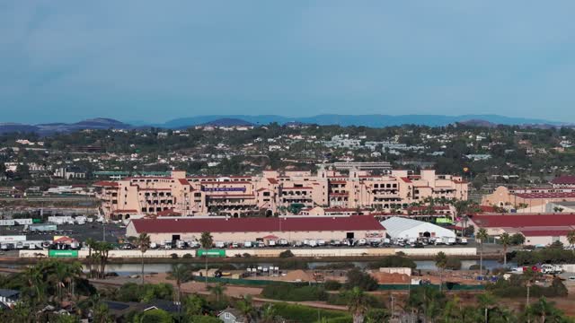 Low aerial view of the country inland, palm trees and homes in Del Mar.