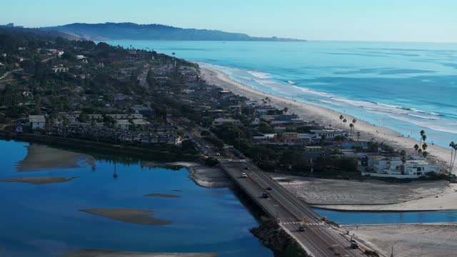 Aerial view of the beach, the surf and the bridge in Del Mar.