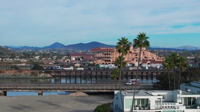 Low aerial view of the country inland, the bridge and palm trees in Del Mar.