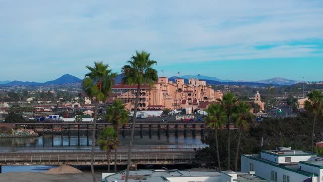 Low aerial view of the country inland, the bridge and palm trees in Del Mar.