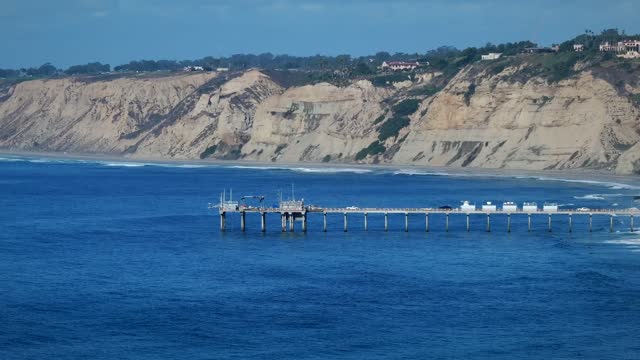 Aerial view of the cliffs, the pier and the ocean at La Jolla Shores.