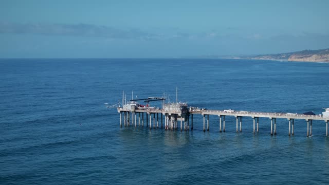 Low aerial view of the beach, the pier and the ocean at La Jolla Shores.