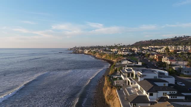 Aerial view of the cliffs, the surf and palm trees at Bird Rock.