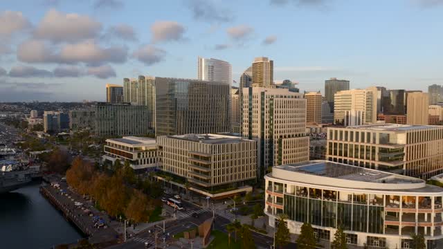Low aerial view of the downtown streets, the bridge and the skyline at Embarcadero.