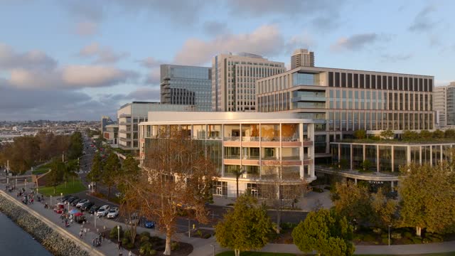 Low aerial view of the downtown streets, homes and the buildings at Embarcadero, with people walking.